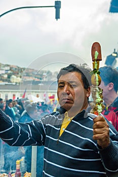 Quito, Ecuador - August 27, 2015: Man selling barbecue skewers in city streets during anti government mass