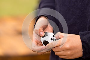 Quito, Ecuador - February 10, 2017: Fidget Cube stress reliever manipulated