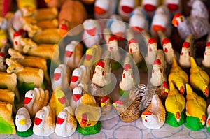 QUITO, ECUADOR- 07 MAY, 2017: Beautiful small figures of hens, ducks and swan made of clay over a white table