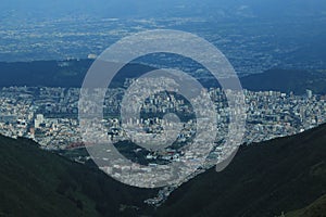 Quito, very large city located in a valley of the andean mountains seen from the top of the mountain Rucu Pinchincha photo