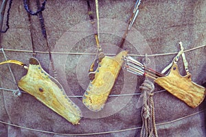 Quivers with vintage bows hanging on the wall of the Yurt Buryats Russia. Weapons for hunting and war Buryat tribes hanging on