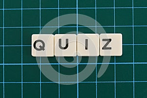 Quiz word made of square letter word on green square mat background