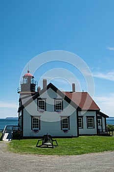 Quoddy Head Lighthouse underneath a bright blue sky