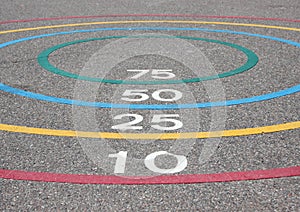 Quoits game with winning circles on asphalt