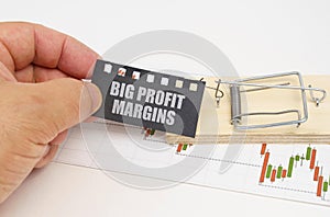 On the quote chart there is a mousetrap from which the hand takes out a sign with the inscription - Big Profit Margins