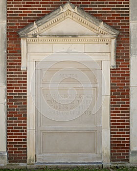 Quote portion of a relief with a Newton bust and quote on the outside wall of a building at Texas Woman`s University.