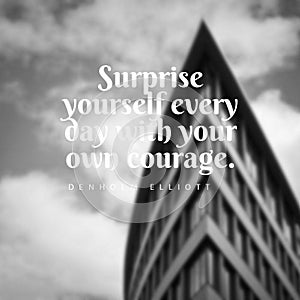 Quote Suprise yourself every day with your own courage. on a grayscale blurry background