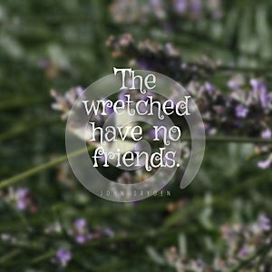 Quote The wretched have no friends. on a blurry floral background photo