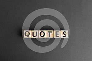 Quotes - word from wooden blocks with letters