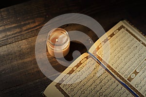 The Qur`an, the holy book of Islam. Kekhusyuan worship month of Ramadan, reading the scriptures by using a candle light