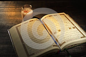 The Qur`an, the holy book of Islam. worship month of Ramadan, reading the scriptures by using a candle light.