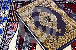 Qur'an over Muslim prayer carpet