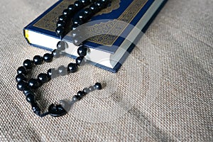 The Quran, also romanized Qur'an or Koran, is the central religious text of Islam. photo