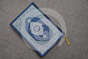 The Quran, also romanized Qur\'an or Koran, is the central religious text of Islam. photo