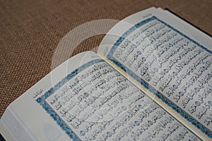 The Quran, also romanized Qur\'an or Koran, is the central religious text of Islam. photo