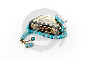 Quran with Blue Rosary - holy book of Muslims - Koran - quran white background