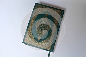 The Quran with a green cover design and ornaments of Islamic calligraphy art