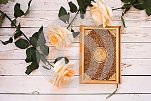 Quran - the holy book of Muslims. Roses.