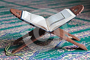 Quran on a wooden stand in mosque.