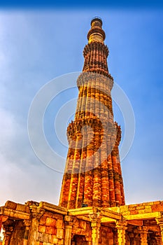 Qutb Minar tower seen through the ruined Quwwat ul-Islam Mosque at Qutub Minar complex - New Delhi, India