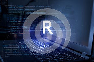 R programming language inscription against laptop and code background. Learn r, computer courses, training