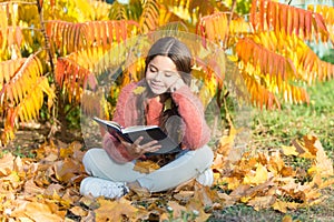 R is for reading. Cute small child learn reading on sunny autumn day. Adorable little girl reading book on natural