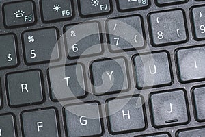 R T Y U keys on a black laptop keyboard..