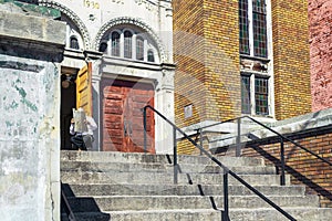 A rabbi reading paper at the entrance to a synagogue