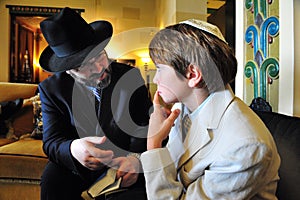 Rabbi teaching a Jewish boy torah for the Bar Mitzvah ceremony