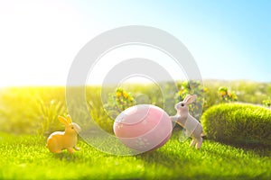 Rabbit and easter eggs in green grass with blue sky.