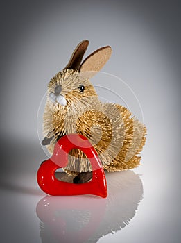 Rabbit figurine with red glass valentine`s heart.
