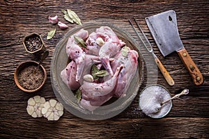 Rabbit. Raw rabbit slices with spices garlic kitchen utensil,fork and butcher. Hunting cuisine