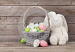 Rabbit toy and easter eggs basket