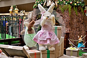 Rabbits dressed on top of gift boxes in the Christmas decoration of the Mall photo