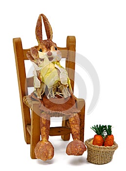 Rabbits papier sitting on chair straw