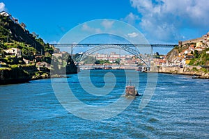 Rabelo Boat approaching the Dom Luis I Bridge in Porto Portugal