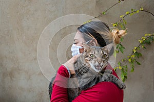 Rabid cat along with a woman holding it in her arms photo