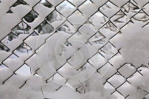 Rabitz. Metallic old mesh covered with snow