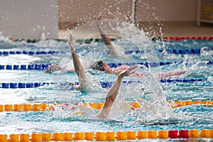 Race of backstroke swimmers in the pool