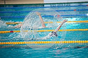 Race of backstroke swimmers in the pool