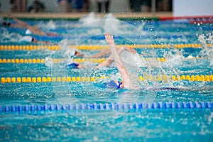 Race of backstroke swimmers in the pool