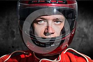 Race car driver wearing protective helmet