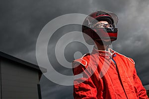 Race car driver wearing protective helmet