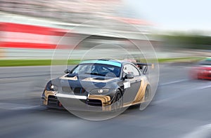 Race cars racing at high speed on a racing track