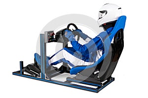 Race driver in blue overall with helmet taining on simracing aluminum simulator rig for video game racing. Motorsport car bucket