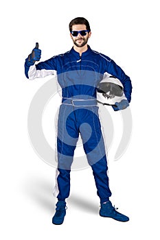 Race driver in blue white motorsport overall shoes gloves and safety gear crash helmet shows thumbs up celebrating after winning