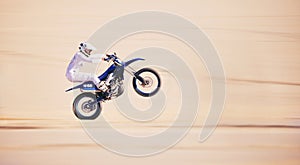 Race, motorbike stunt and person in desert, action and extreme sport, speed riding outdoor and mockup space. Adventure