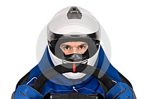 Race or rallye driver blue overall suit with steering wheel and crash helmet in racing seat isolated  white background. motorsport photo