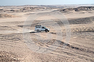 Race in sand desert. Car suv overcomes sand dunes obstacles. Competition racing challenge desert. Car drives offroad