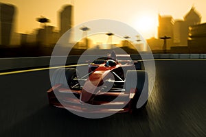 A racecar speeding in a track with a city background photo